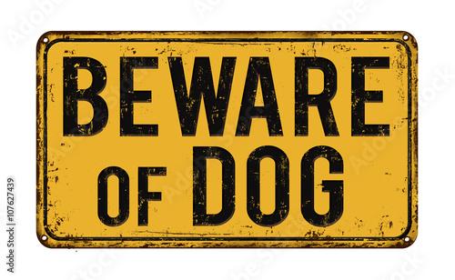 Beware of dog on yellow vintage rustic retro sign